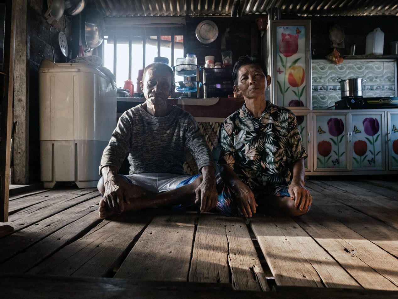 Badak and his wife, Peri, in the kitchen of their stilt house in Tanjung Gundap, Batam, where they have lived since the early 1980s.