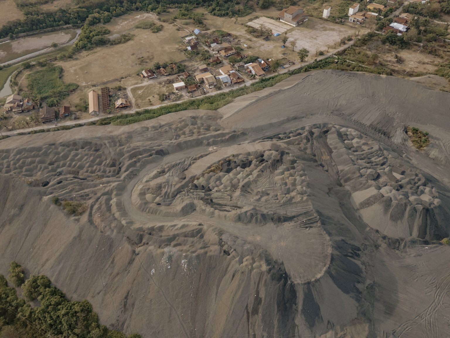Nickel-processing waste from PT Huadi Nickel-Alloy Indonesia piled near homes in Mawang hamlet, Bantaeng, South Sulawesi.