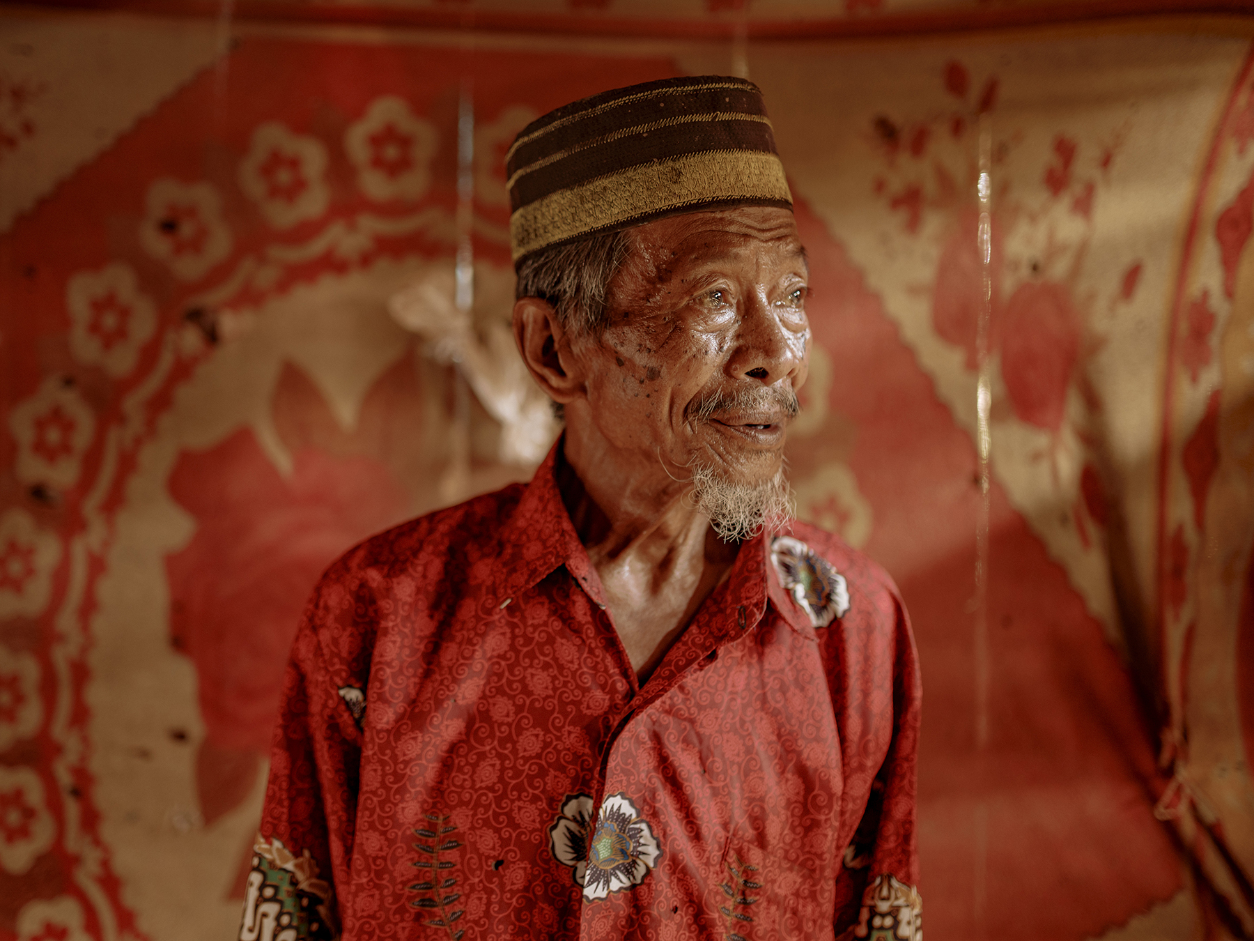 Ambo Enre, 77, has witnessed every change that has come to Papanloe village in Pa’jukukang, Bantaeng. Since the Bantaeng Industrial Park began operating, he has never received any aid from the companies behind the “strategic” project. He lives in a dilapidated stilt house, coated in ever-present dust drifting in from the industrial site.