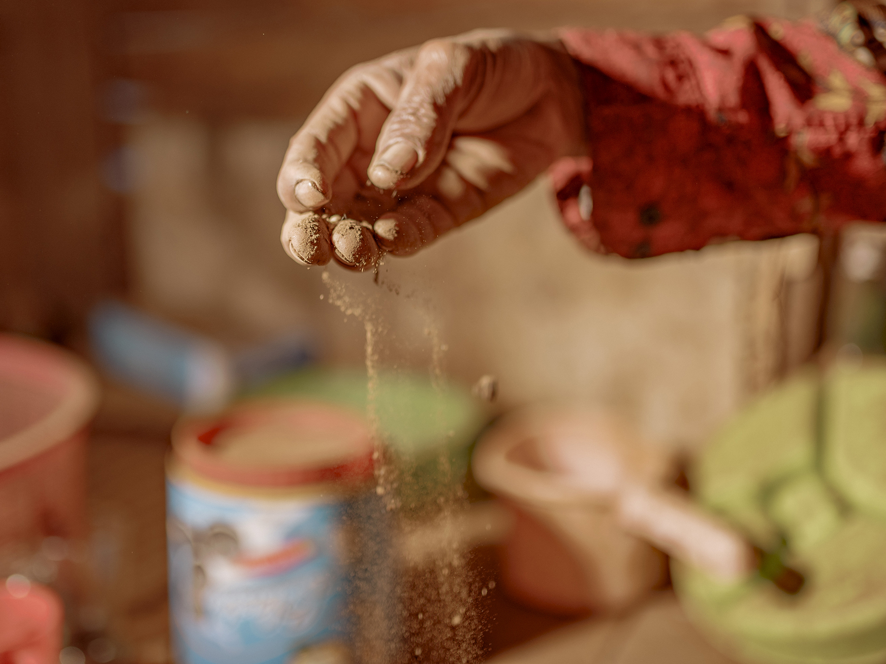Ambo Enre shows the dust accumulating in his living room. His stilt house in Papanloe village stands between two nickel smelter facilities operating day and night. His wife has moved to another home after developing a persistent cough and breathing difficulties.