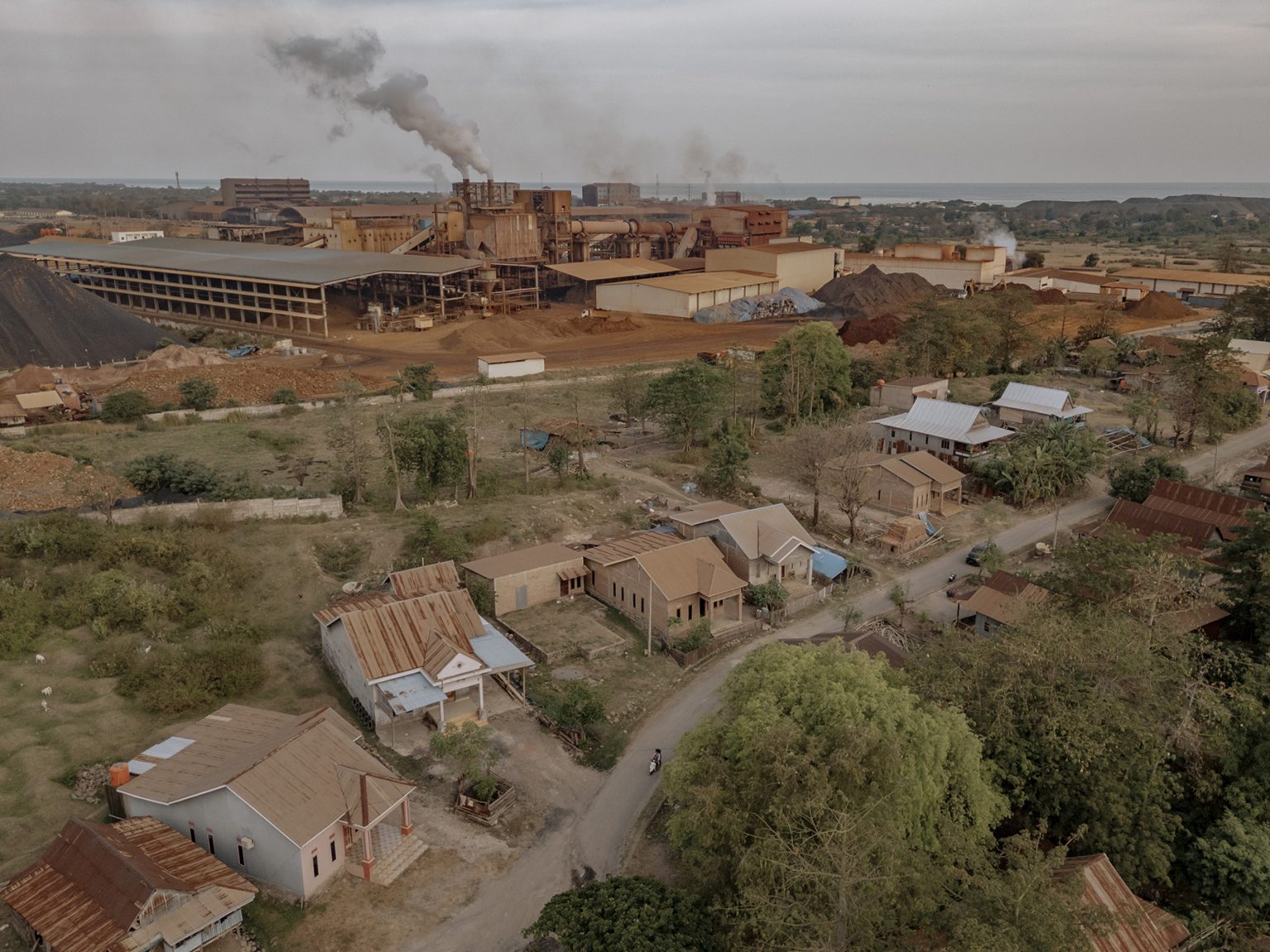 An aerial view of nickel smelters operated by PT Hengsheng New Energy Material Indonesia at the Bantaeng Industrial Park (BIP) in South Sulawesi. The complex borders residential homes in Papanloe village, where residents contend with dust pollution every day.
