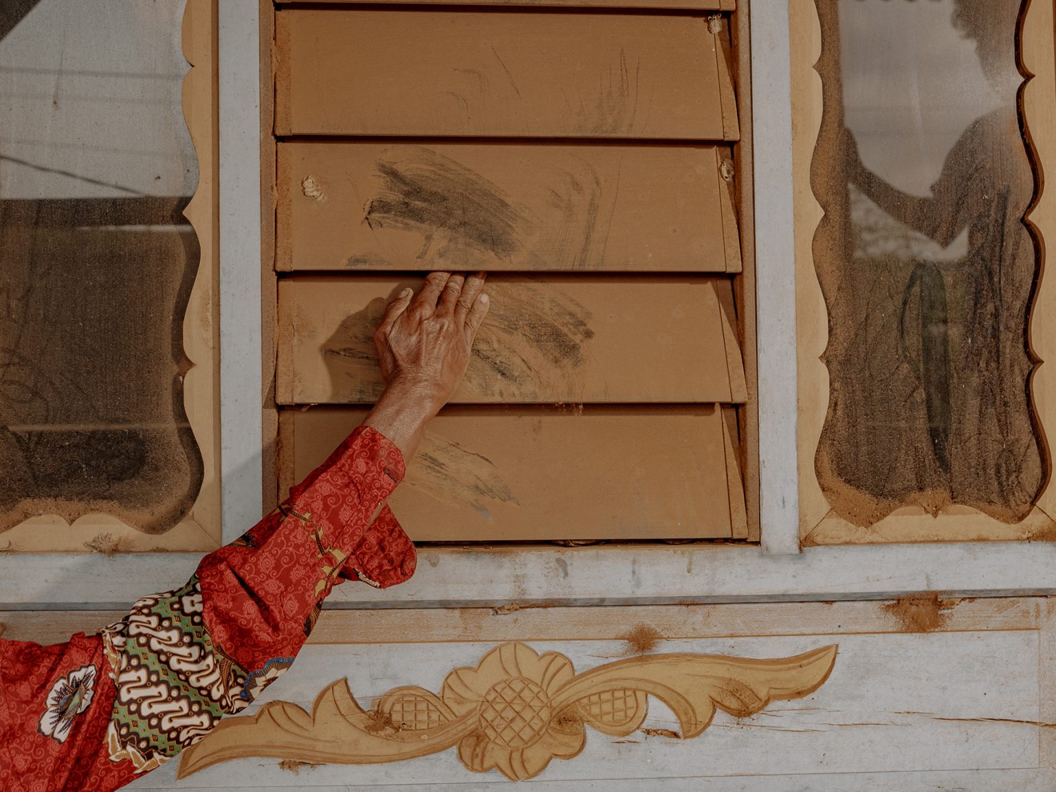 Thick layers of dust coat the windowpanes of a resident’s home in Papanloe village, which is wedged between two nickel smelter complexes operated by PT Hengsheng New Energy Material Indonesia and PT Unity Nickel Alloy Indonesia.