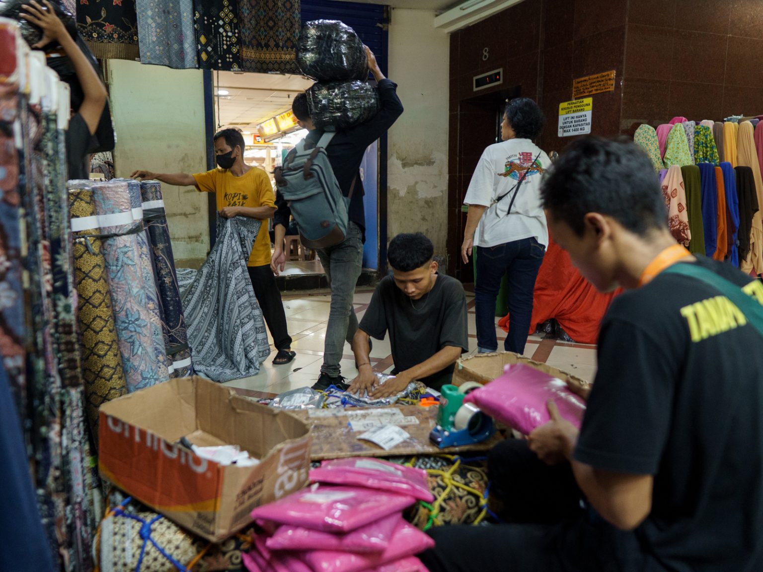 Loading and unloading activities at Tanah Abang Market in Central Jakarta, May 2026. Plastic is widely used for shopping bags, material wrapping, and package deliveries.
