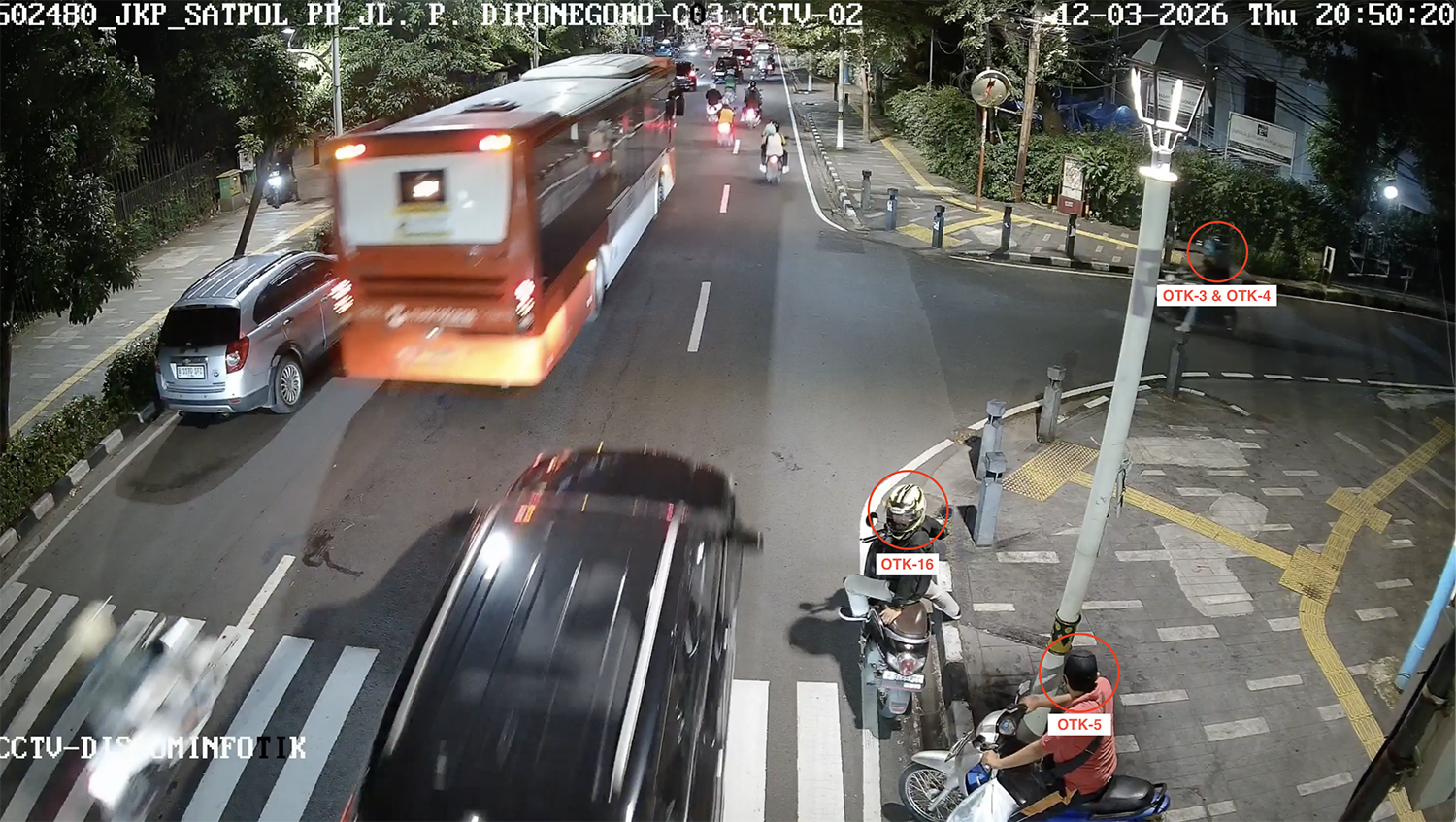 Suspect No. 16 is seen about to cross the street alongside Suspect No. 5 near the YLBHI office on the night of the attack.