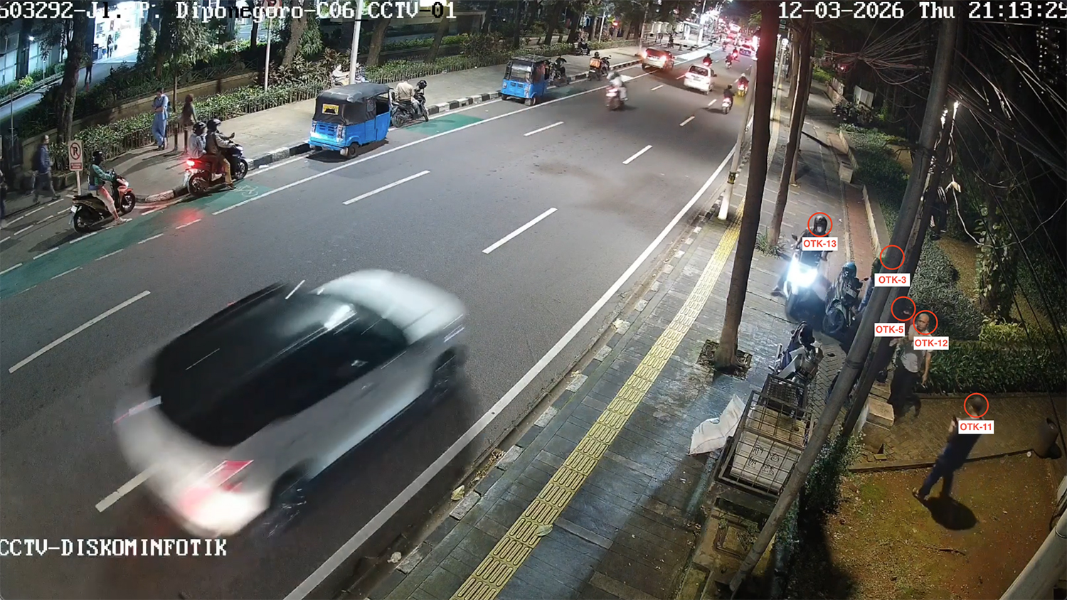Suspect No. 12, identified as RD, speaks with Suspect No. 5 without his helmet.