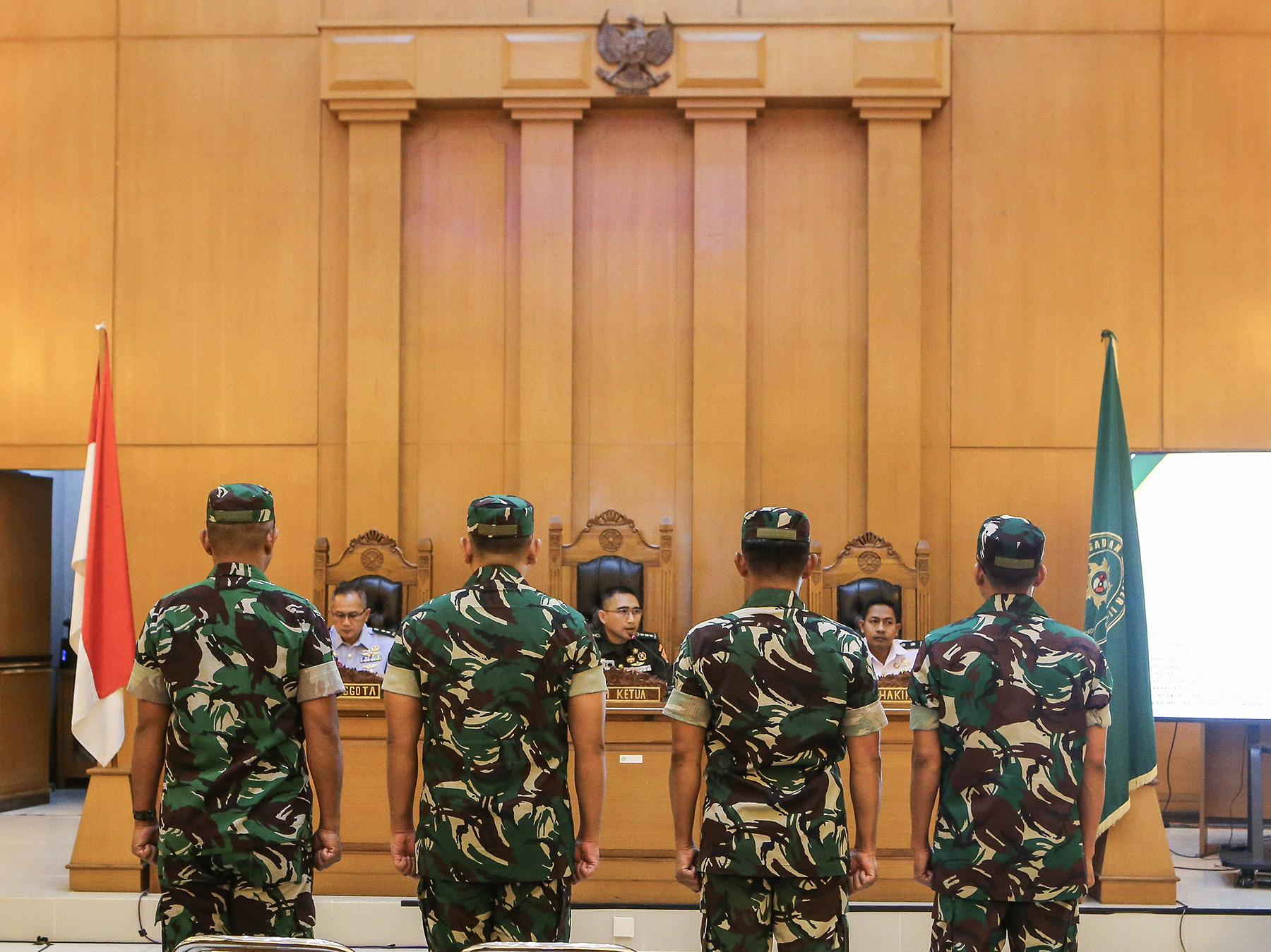 Army Colonel Fredy Ferdian Isnartanto, Lieutenant Colonel Irwan Tasri, and Major M. Zainal Abidin preside over the military trial of four soldiers accused of attacking Andrie Yunus with acid. The Advocacy Team for Democracy (TAUD) reports the three judges to the Supreme Court over alleged violations of the judicial code of ethics.